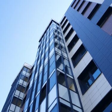 A residential apartment building from top to bottom. Commercial real estate, building. Buying, renting real estate. City apartments.